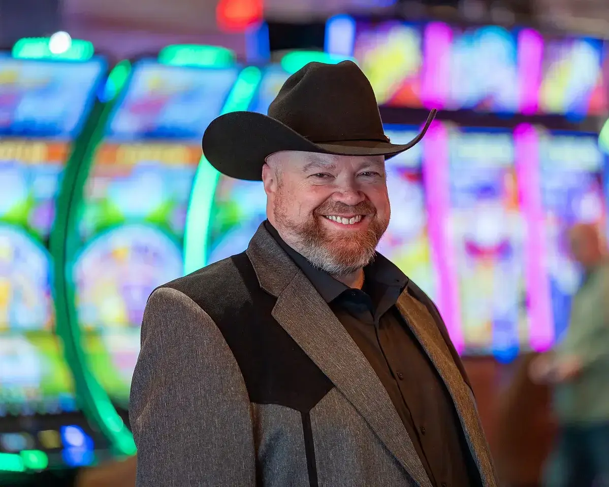 Smiling man in cowboy hat indoors