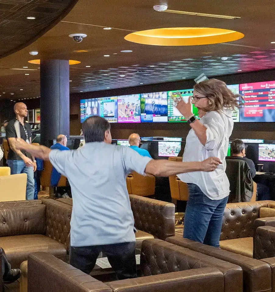 People celebrating in a sports betting lounge