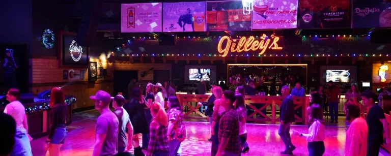 People dancing in vibrant nightclub under neon lights