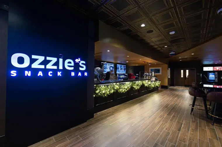 Ozzies Snack Bar entrance with illuminated sign