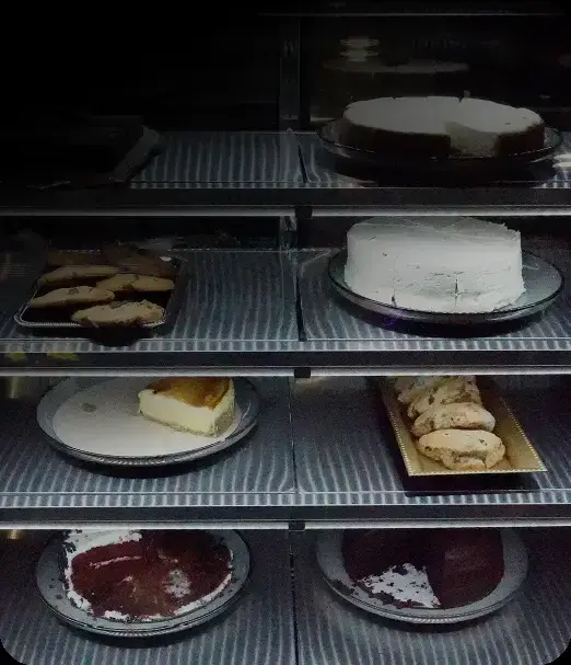 Assorted cakes and pastries on display shelves