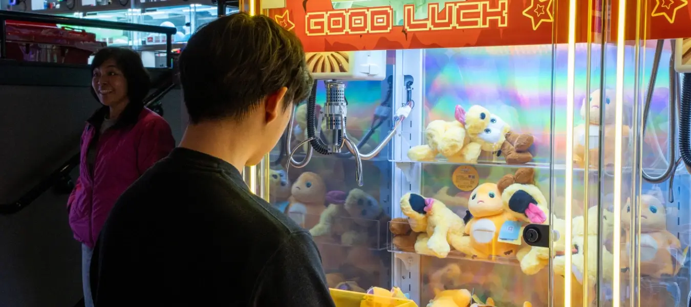 Person playing a claw machine